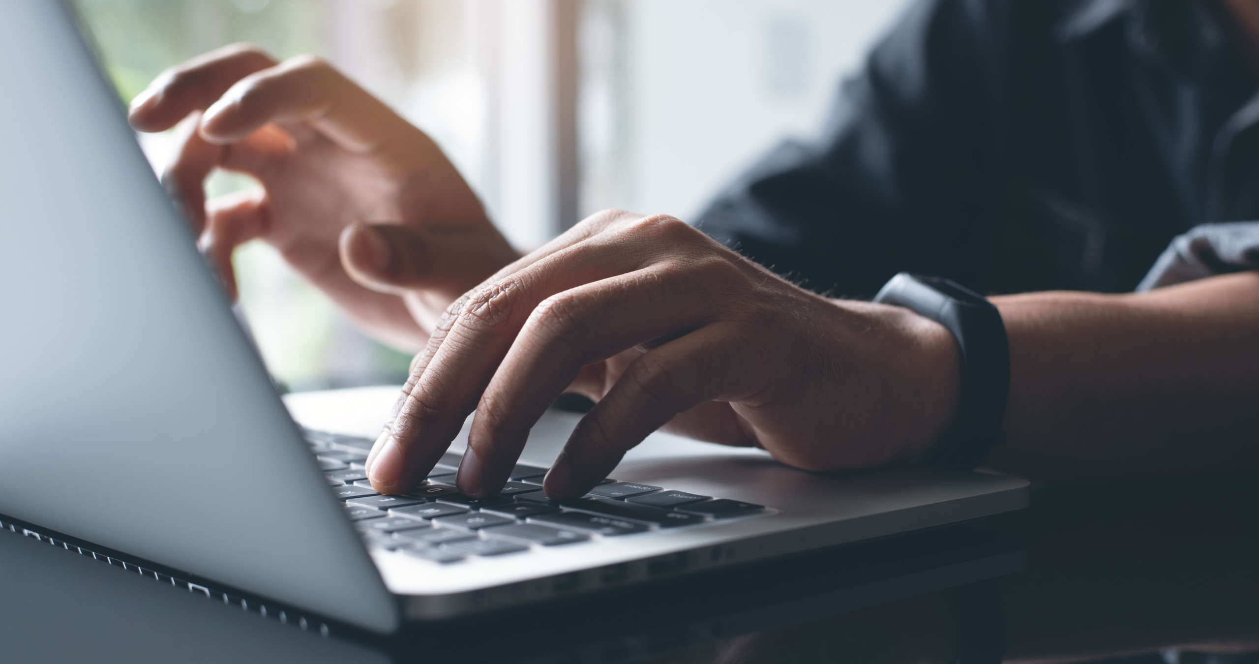 man typing on a computer