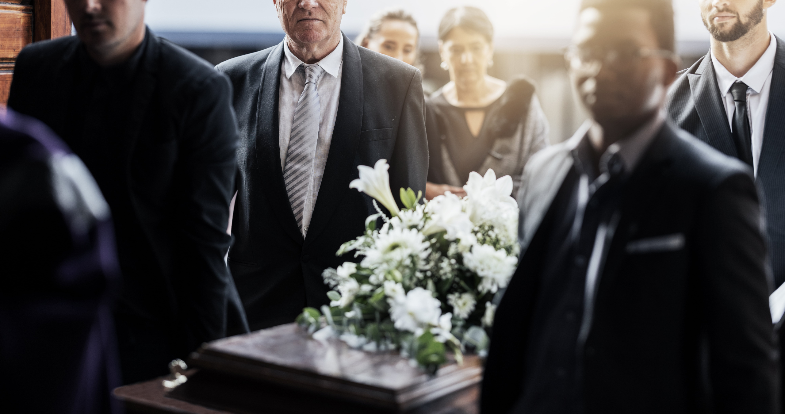 pallbearers caring a casket