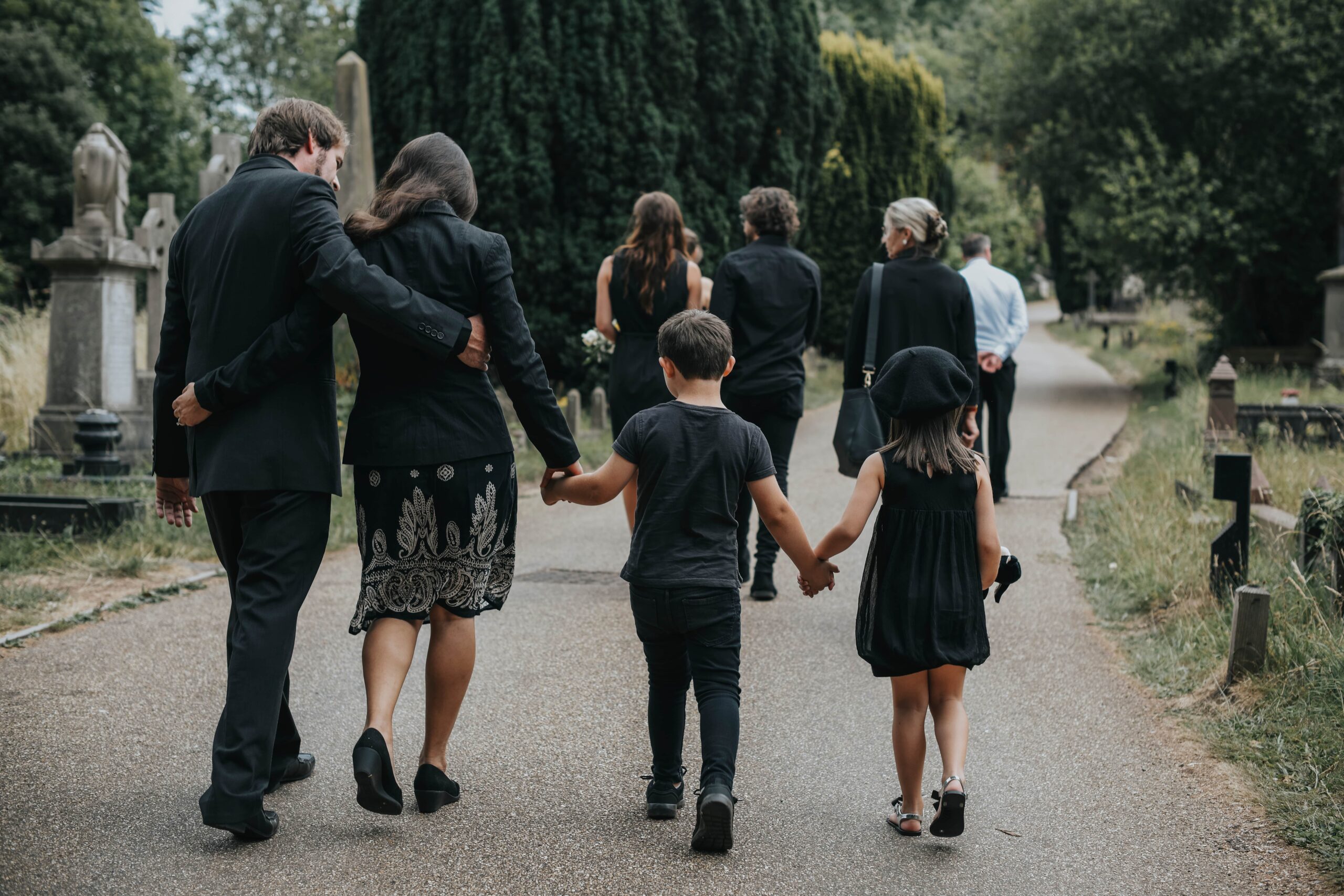 people walking in a cemetery